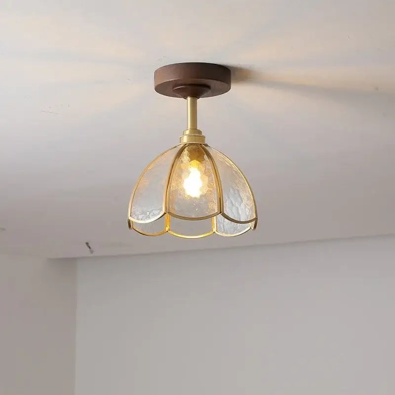 A warm-toned brass and textured glass decorbites led glass wood ceiling lamp with a petal-shaped design for modern indoor lighting