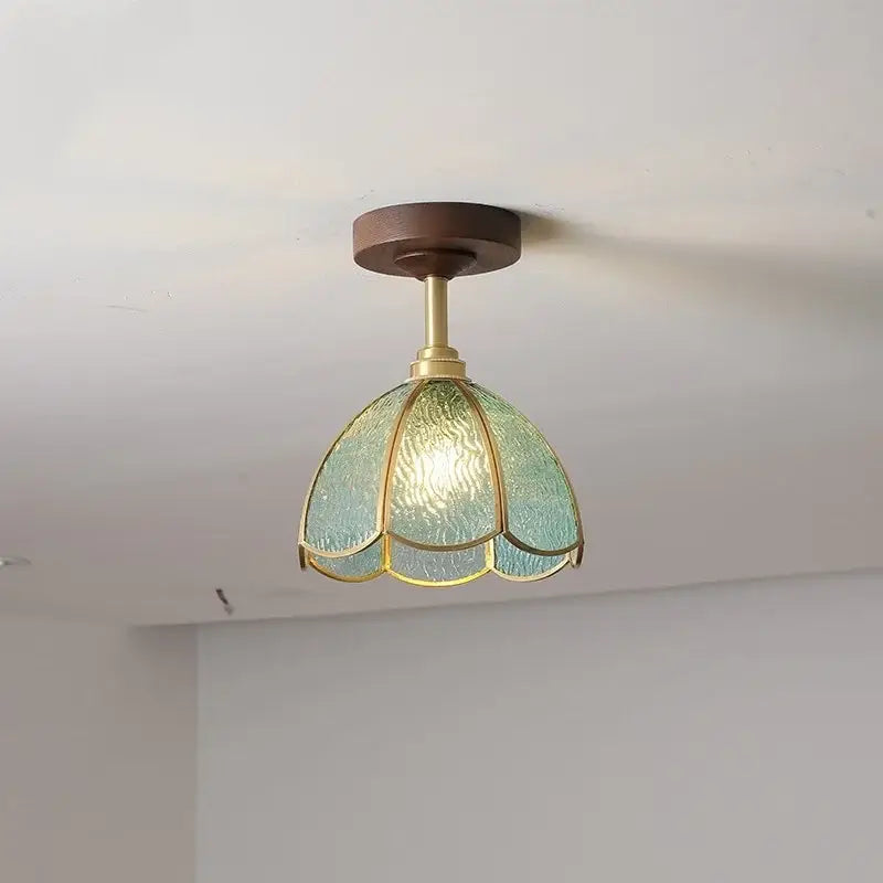 A delicate teal glass ceiling lamp with brass frame and wooden mount from DecorBites LED glass wood collection