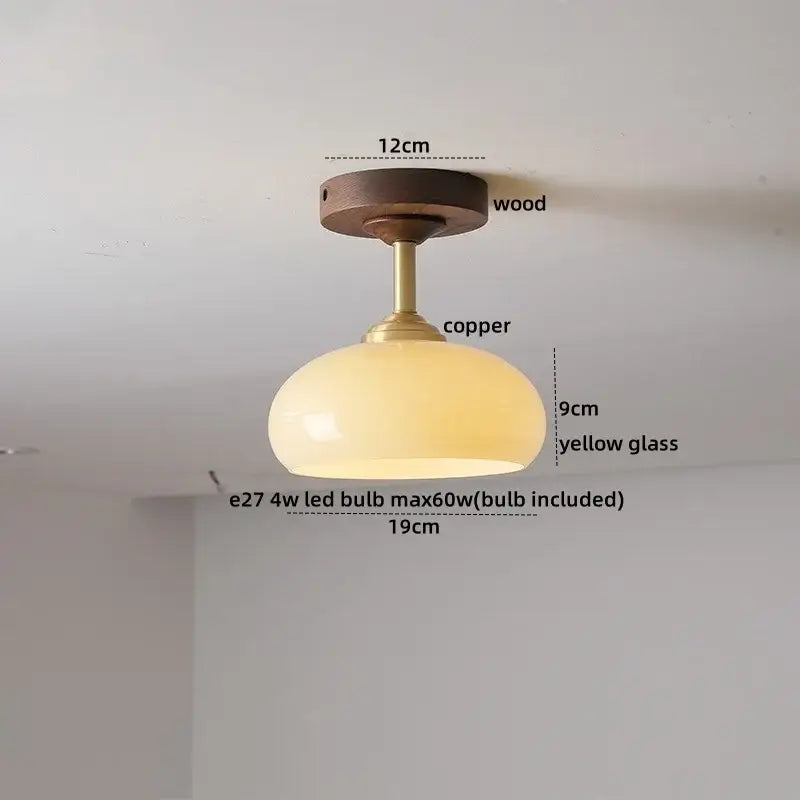 A decorbites led glass wood ceiling lamp with a warm yellow glass shade copper stem and wooden mount for modern indoor lighting