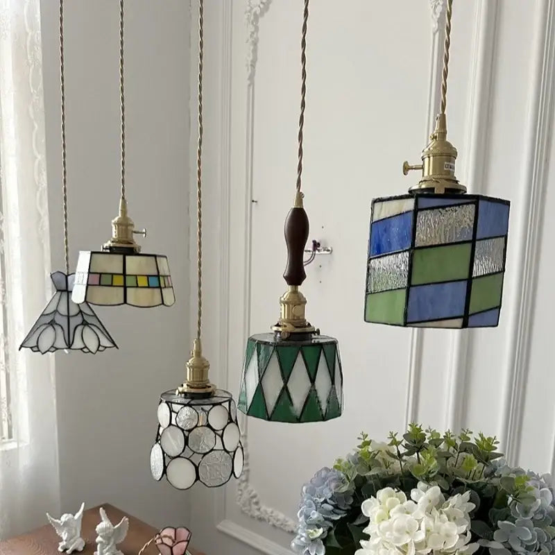 Three vintage-style decorbites led glass pendant lamps with colorful geometric stained glass and brass fixtures