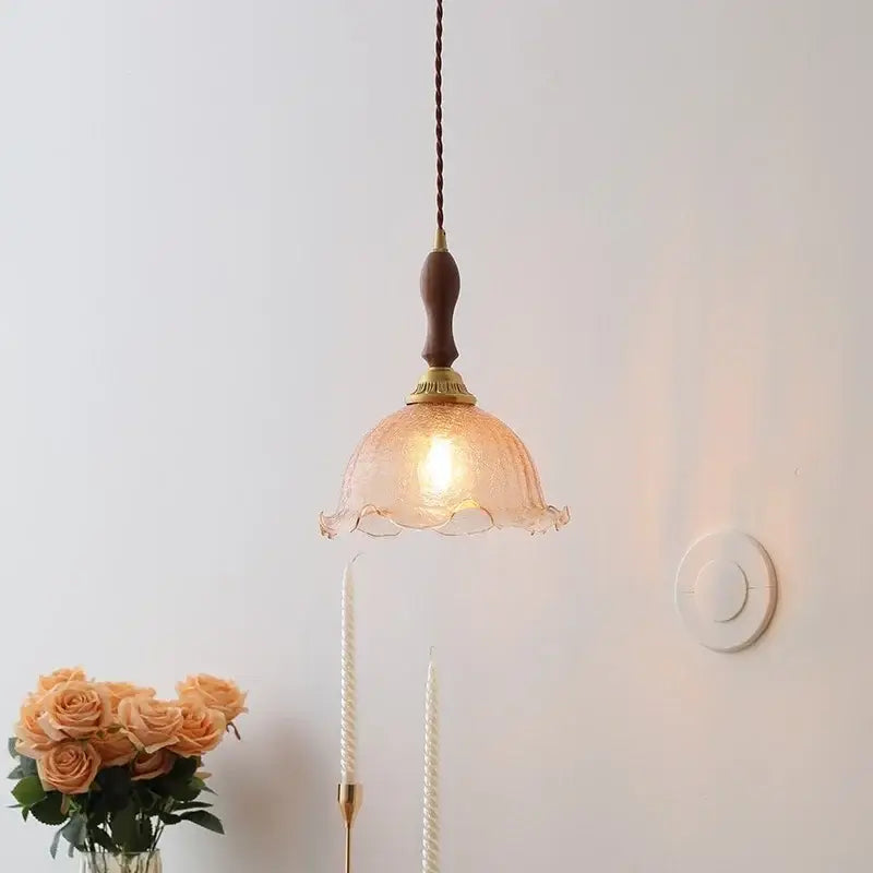 Warm-toned amber glass wood pendant light with wooden handle and brass accents for modern Nordic home décor
