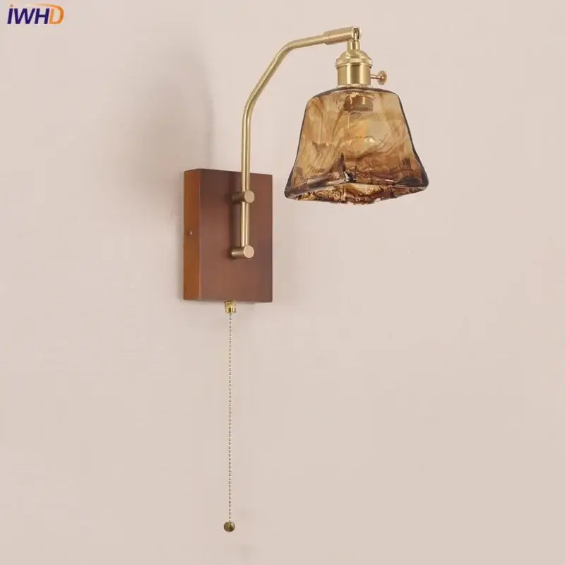 Brass-finished decorbites led wall lamp with textured amber glass shade and wooden base for living room and bedroom