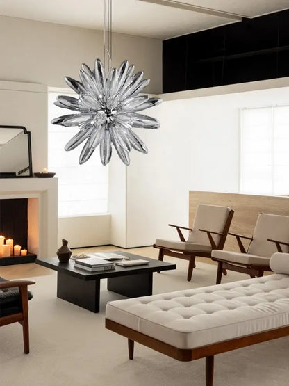 A modern decorbites led globe 2025 chandelier in chrome and gold with clear glass petals and a metallic frame