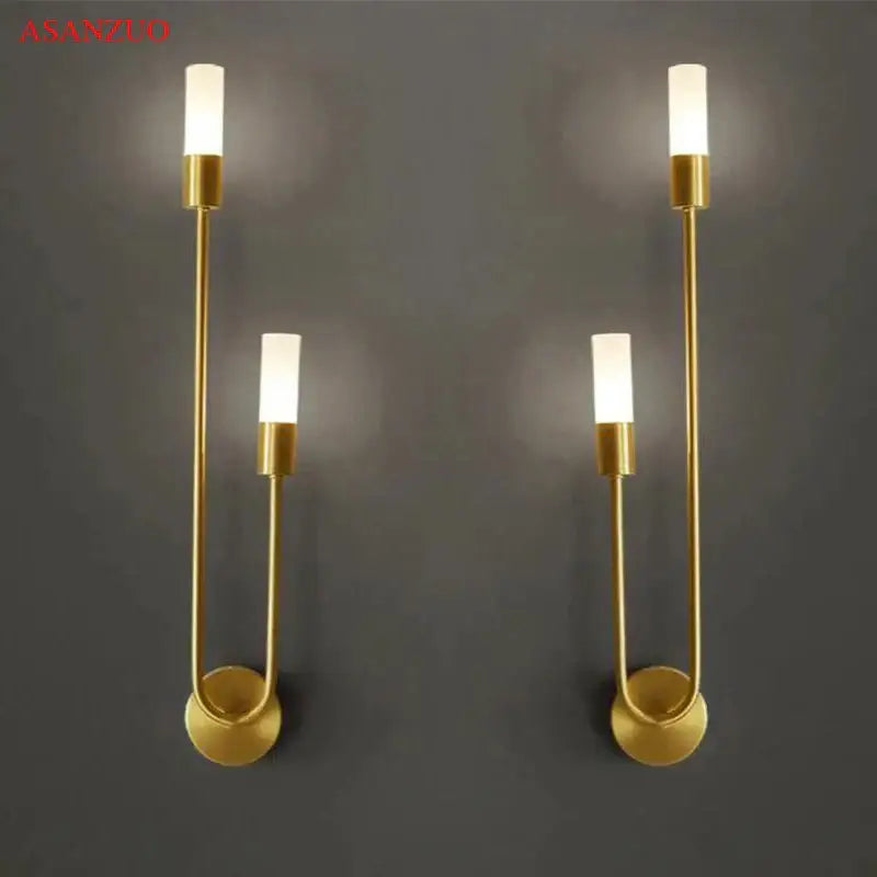 Gold-toned decorbites led candlestick wall light with sleek curved metal arms and frosted glass shades for indoor decor