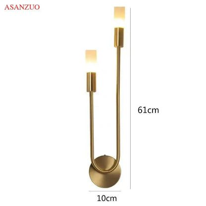 Gold-toned decorbites led candlestick wall light with two upward cylindrical fixtures and curved metal base for indoor decor