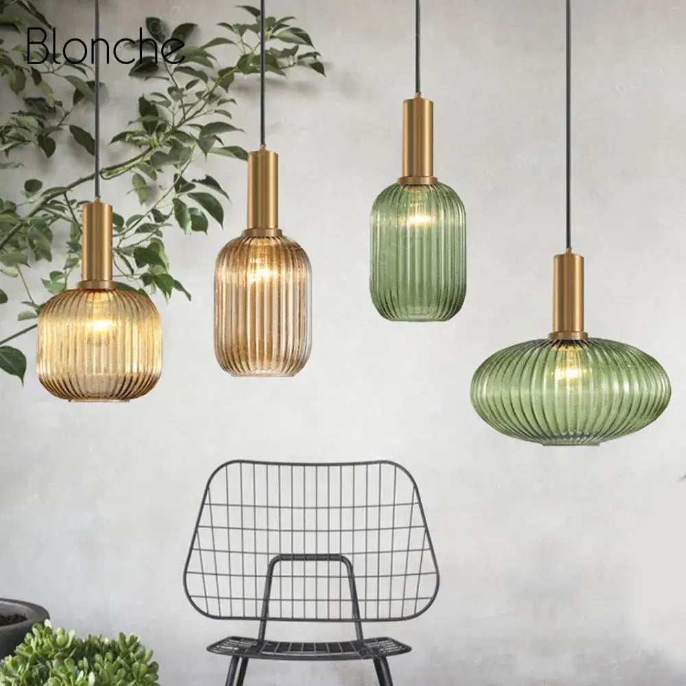 Four elegant decorbites led gold chandelier pendant lamps with ribbed amber and green glass shades and brass accents