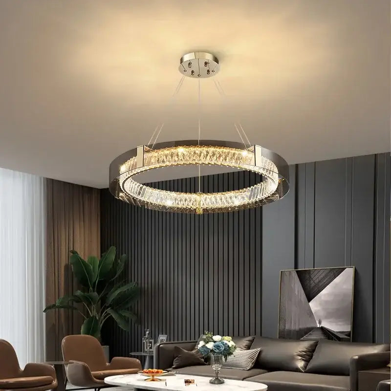 Modern circular DecorBites™ LED gold crystal glass chandelier with sleek chrome frame and cascading crystals for living spaces