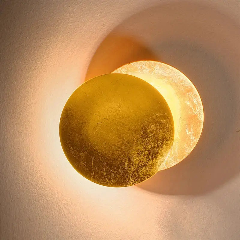Warm-toned circular wall lamp with textured translucent amber gold finish decorbites led gold eclipse circle design