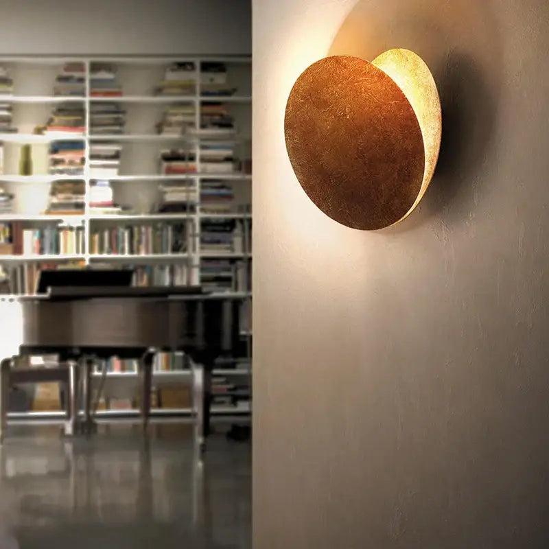 Warm-toned decorbites led gold eclipse circle wall lamp with textured metallic finish for bedroom and living room