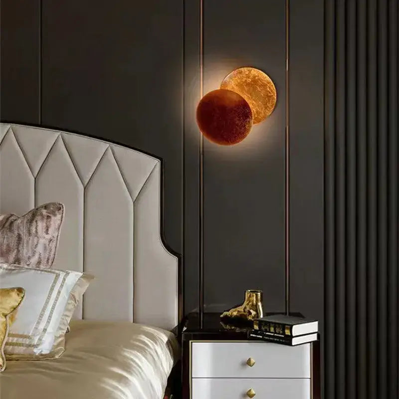 Golden and reddish-orange spherical wall lamp with textured celestial design decorbites led gold eclipse for bedroom use
