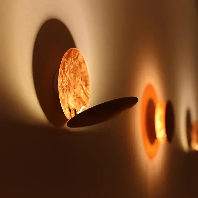 Decorbites led gold eclipse wall lamp warm-toned circular sconce with golden-brown metallic finish and black accent plate