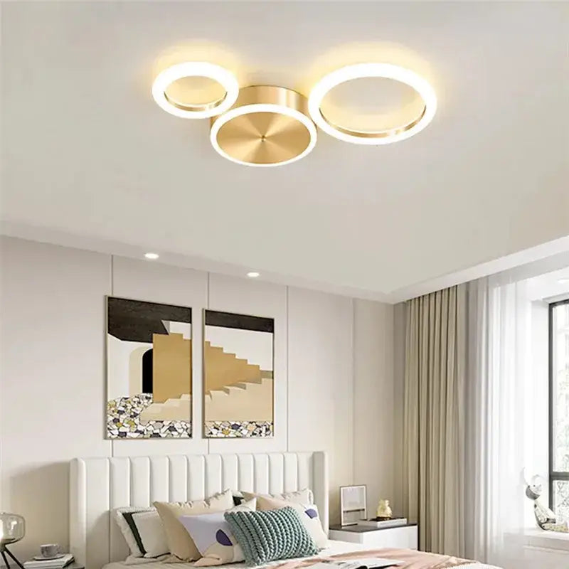 Modern gold-toned decorbites led gold ring chandelier with three interconnected rings for living and dining rooms