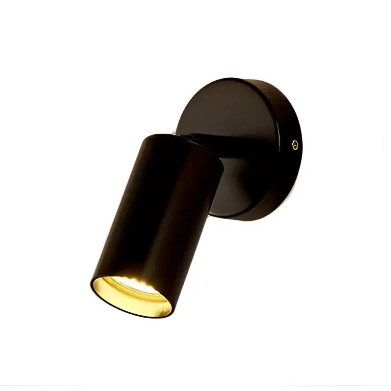 Black matte adjustable spotlight with warm yellow light from its cylindrical head in decorbites led gold round wall lamp
