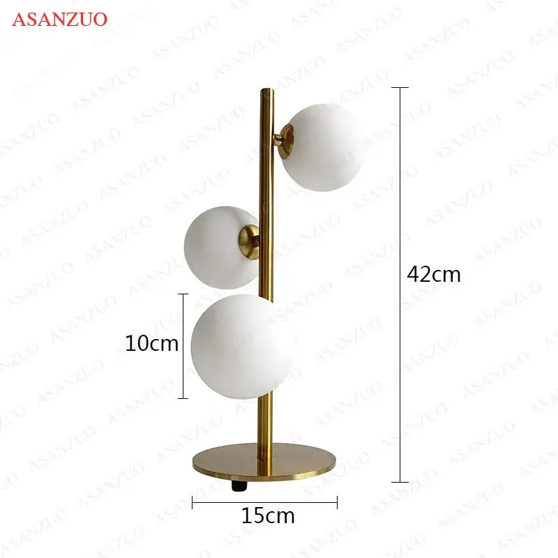 DecorBites™ LED gold table lamp with three milk white glass spherical white glass lampshades in a vertical cluster