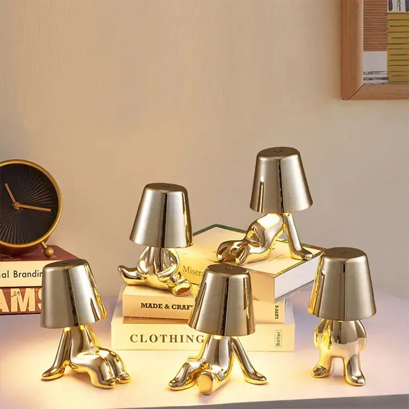 Golden lamp-shaped figurines with reflective resin surfaces of decorbites led golden boy table lamp for bedroom decor