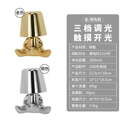 Gold-colored glossy resin decorbites led golden boy table lamp shaped as seated figure with bell-shaped shade for bedroom decor