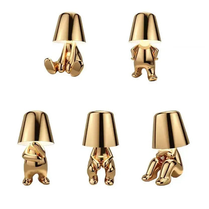 DecorBites led golden boy table lamp is a gold resin minimalist figurine lamp emitting warm rechargeable light