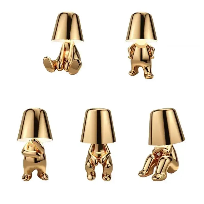 DecorBites led golden boy table lamp is a gold resin minimalist figurine lamp emitting warm rechargeable light