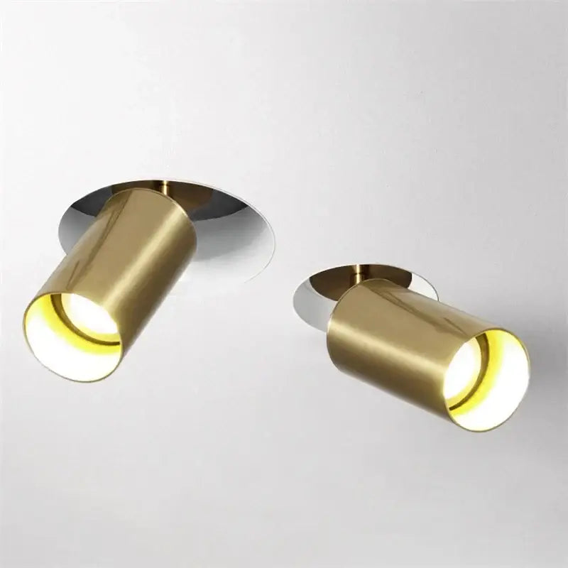 Two sleek brushed brass cylindrical decorbites led golden ceiling lights with polished chrome mounting plates for living room