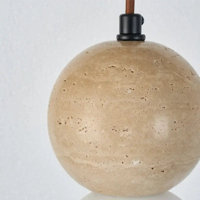 Beige spherical stone pendant light with black metal fixture and brown leather cord decorbites led gourd pendant