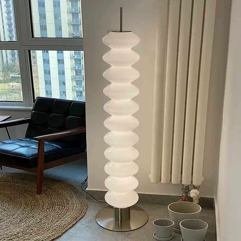 A modern translucent white floor lamp with stacked segments and metallic base decorbites led gourd sanding design