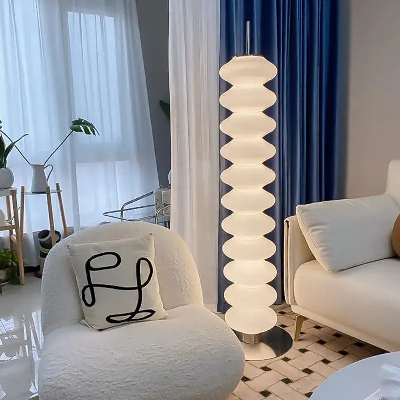 A decorbites led gourd sanding floor lamp with stacked white oval segments and a sleek metallic base for modern spaces