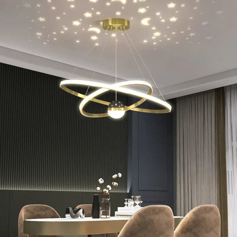 Gold-toned led gypsophila chandelier with intertwined rings and globe light casting starry patterns on ceiling