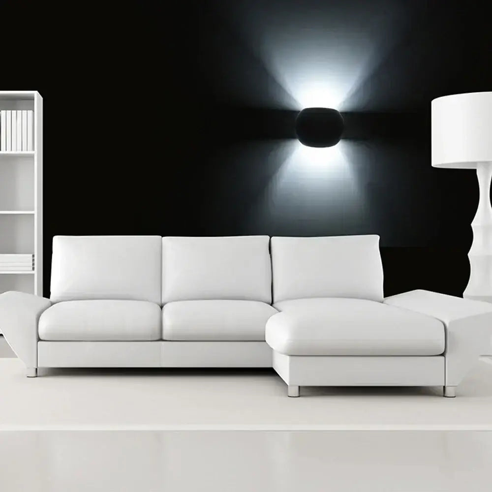 White leather sectional sofa with clean lines and modern design paired with decorbites led gypsum wall sconce for elegant lighting