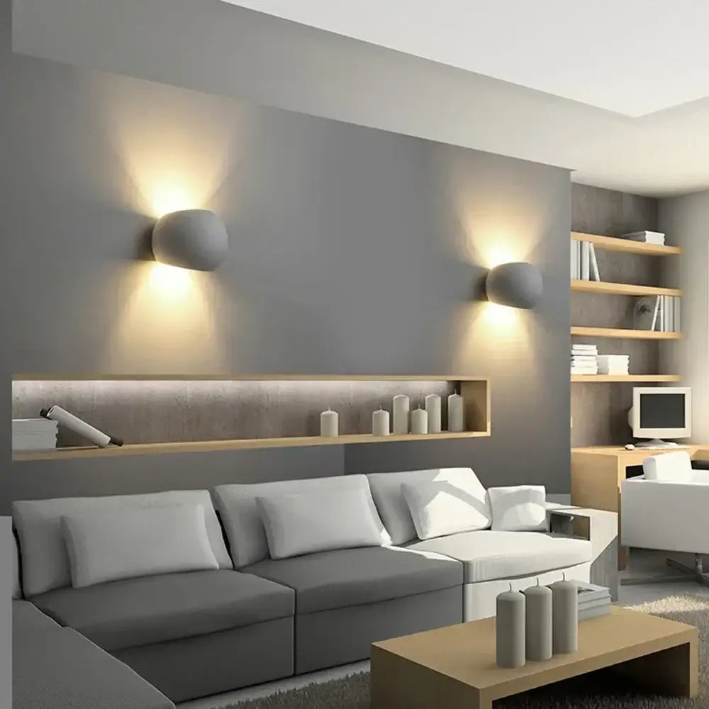 Modern gray DecorBites LED gypsum wall sconce with rounded design emitting warm light for bedroom and living room decor