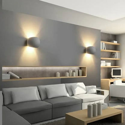 Modern gray DecorBites LED gypsum wall sconce with rounded design emitting warm light for bedroom and living room decor