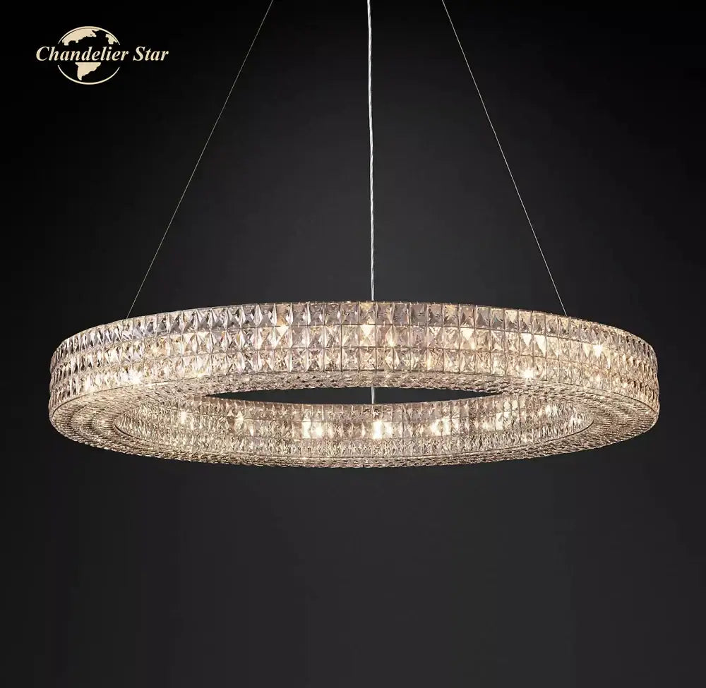 A double-tiered circular decorbites led halo crystal chandelier with faceted crystals suspended by thin wires against dark background