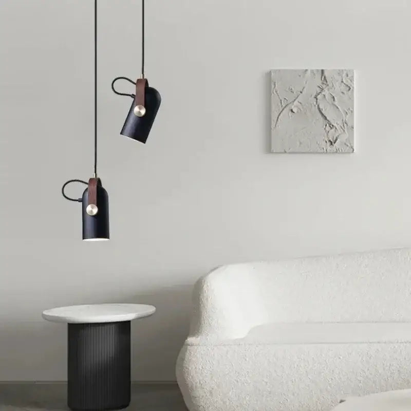 Two sleek black pendant lights with brown leather straps and metallic accents from DecorBites led hanging lamp for bar and dining room