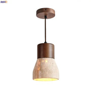 A rustic decorbites led hanging lamp with dark wood stem and textured yellow travertine concrete shade for warm lighting