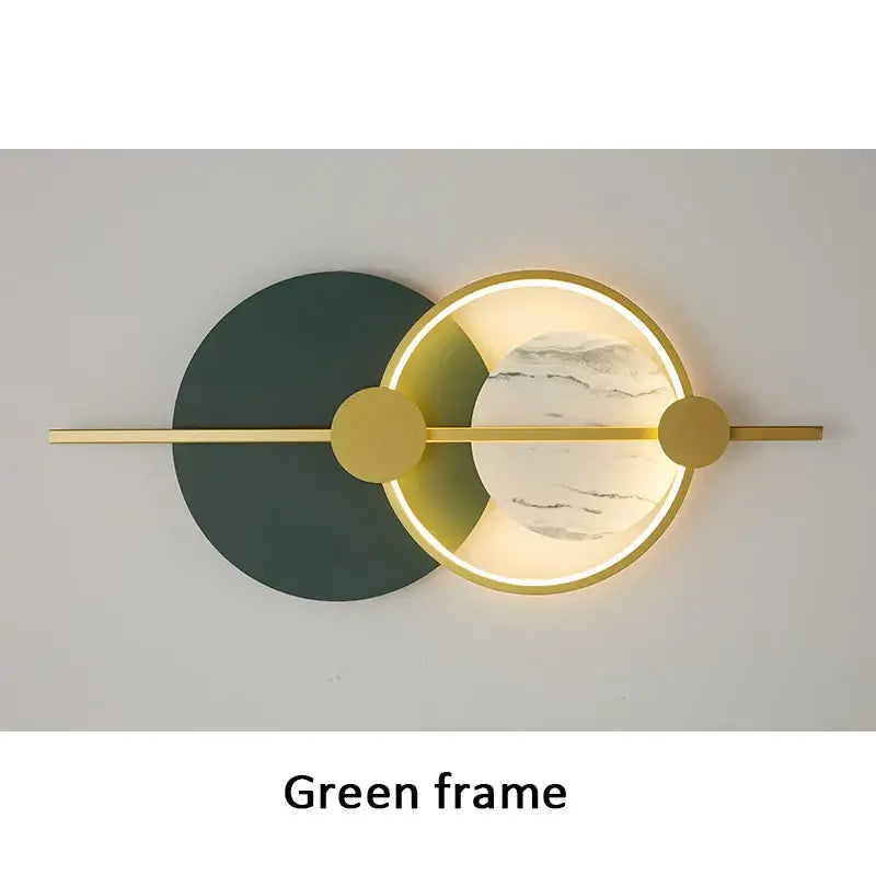 Modern geometric decorbites led home wall lamp with matte green frame gold accents and illuminated marble disc for living room lighting