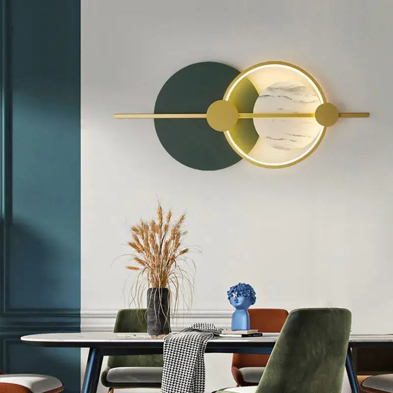 Modern gold-toned DecorBites LED home wall lamp with circular marble-patterned illuminated face and geometric accents