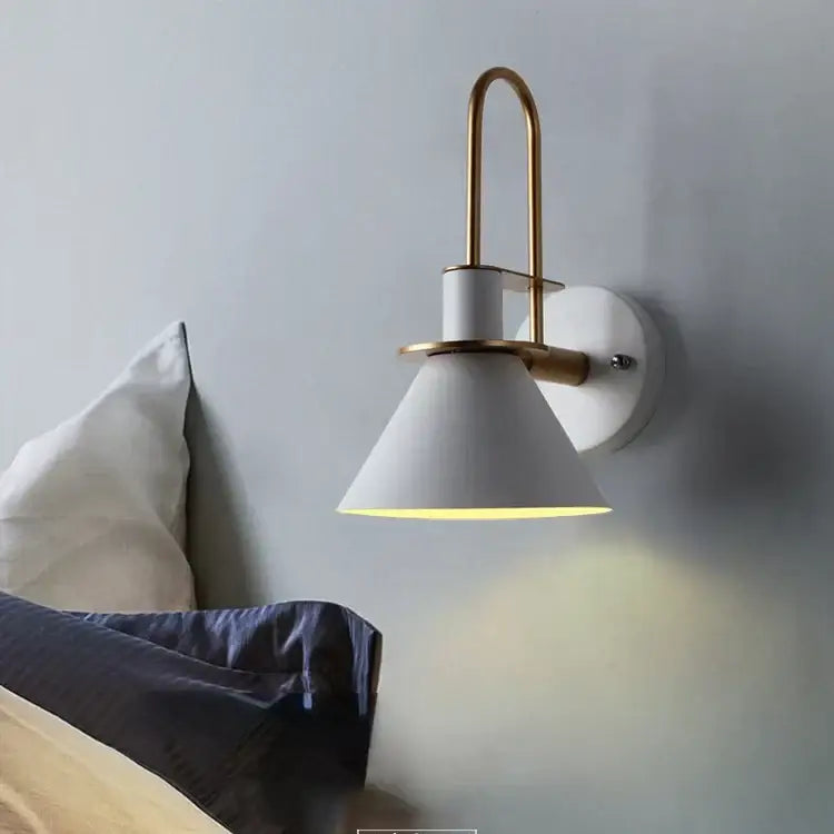 White conical wall lamp with brass arched arm and circular backplate decorbites led horn wall sconce for modern decor