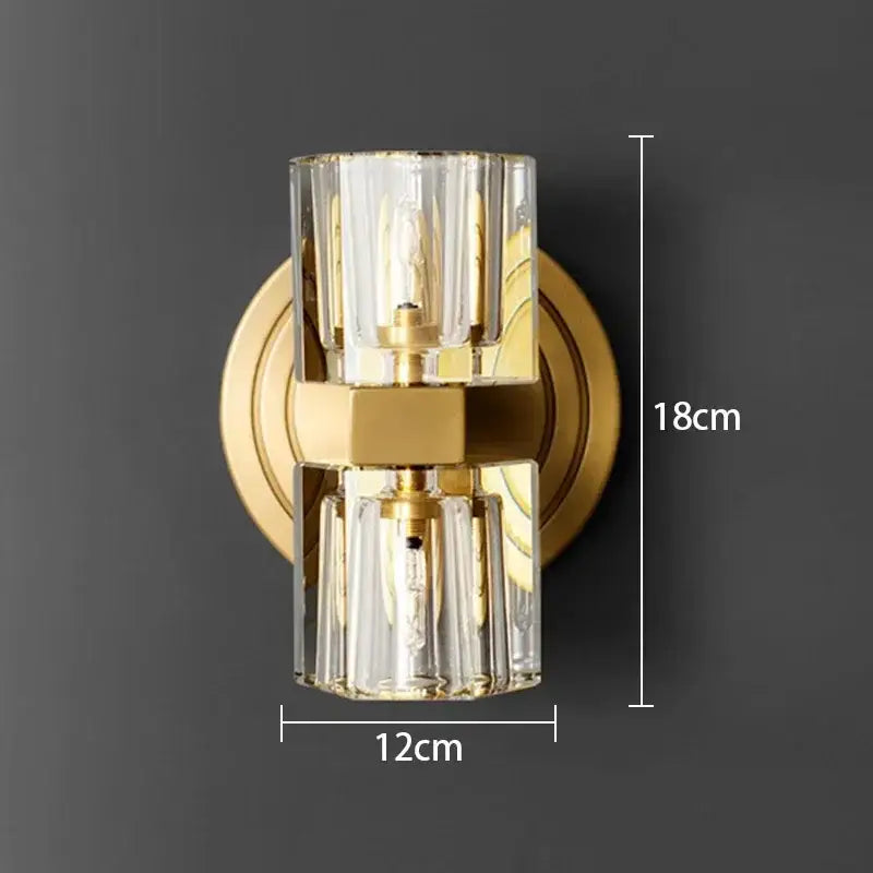 Gold-toned DecorBites LED indoor bedside lamp with two clear faceted glass cylinders and central brass accent