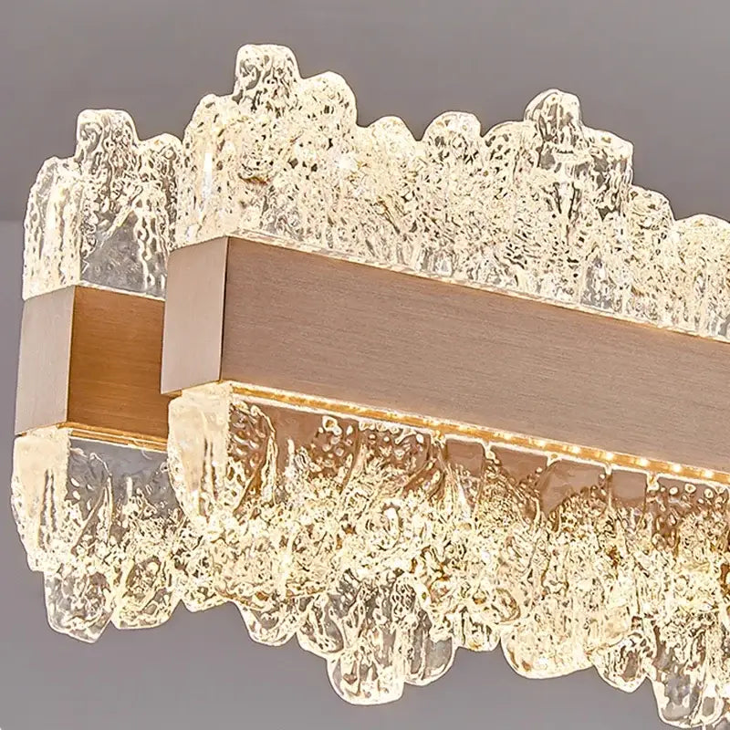 Modern rectangular decorbites led indoor chandelier lighting with textured translucent glass and brushed brass bar for bedroom