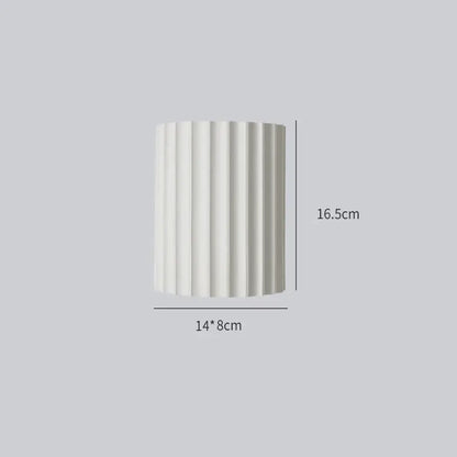 A sleek white cylindrical decorbites led indoor wall lamp with vertical ridges for living room and bedroom lighting