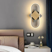 Modern decorbites led indoor wall light with sleek oval frame warm light and central wooden square accent for home lighting