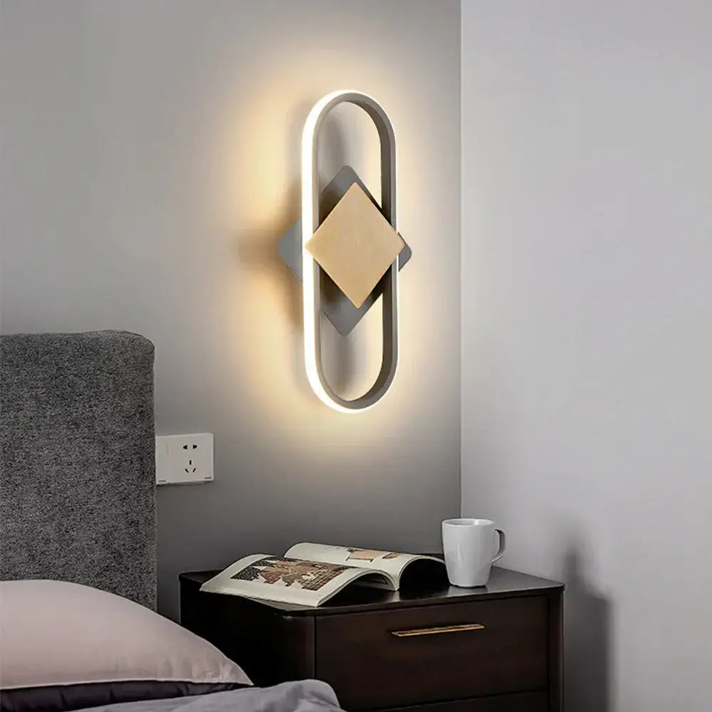 Modern oval-shaped decorbites led indoor wall light with sleek metallic frame warm led lighting and gold geometric accents