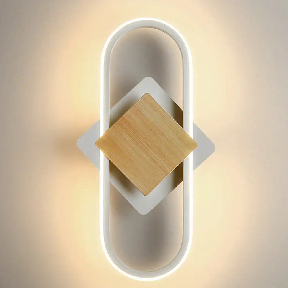 Modern white decorbites led indoor wall light with sleek oval frame and central square wooden accent for home lighting