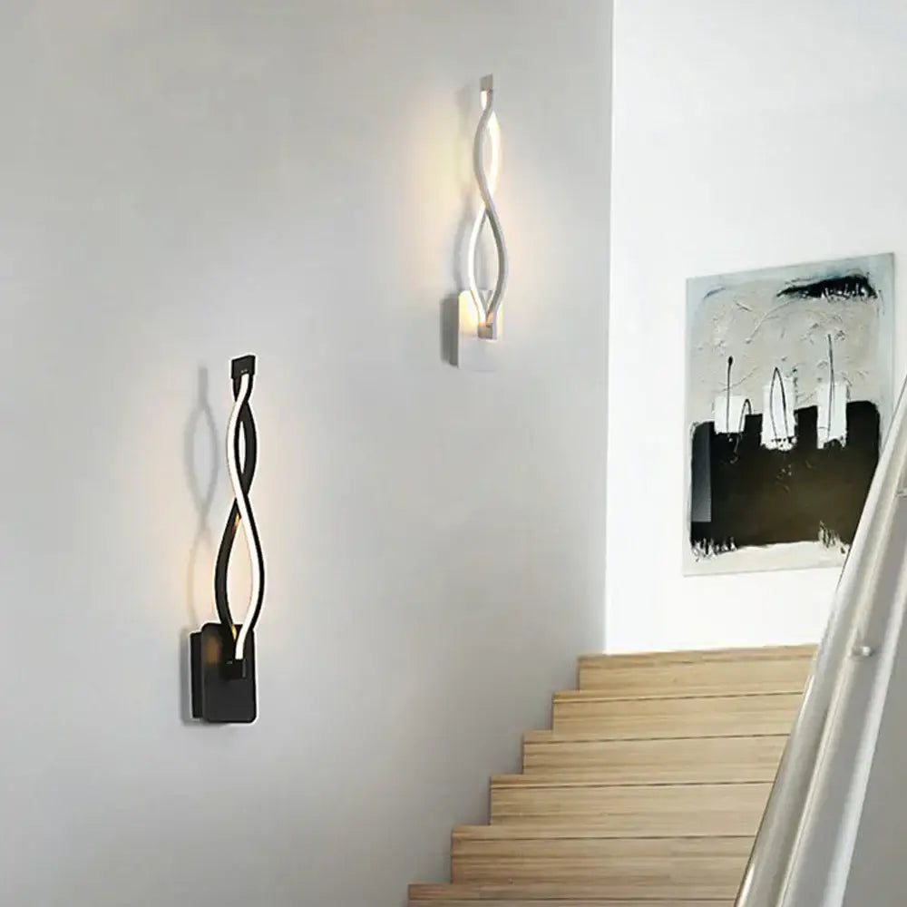 Modern twisted decorbites led indoor wall light in black and silver finishes emitting warm glow for home lighting