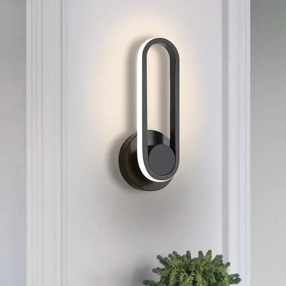 Modern black decorbites led indoor wall light with illuminated oval frame and circular base for home lighting