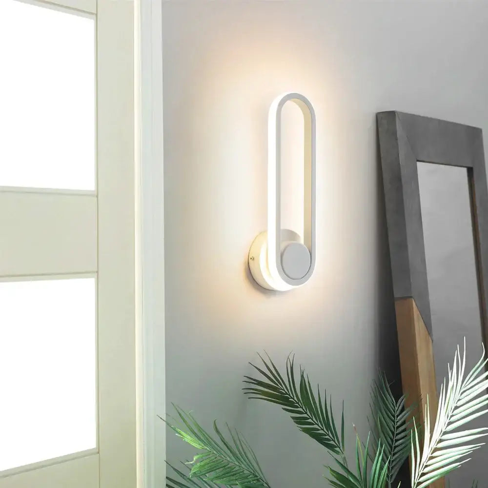 Modern white decorbites led indoor wall lamp with sleek elongated oval design and circular base for home lighting