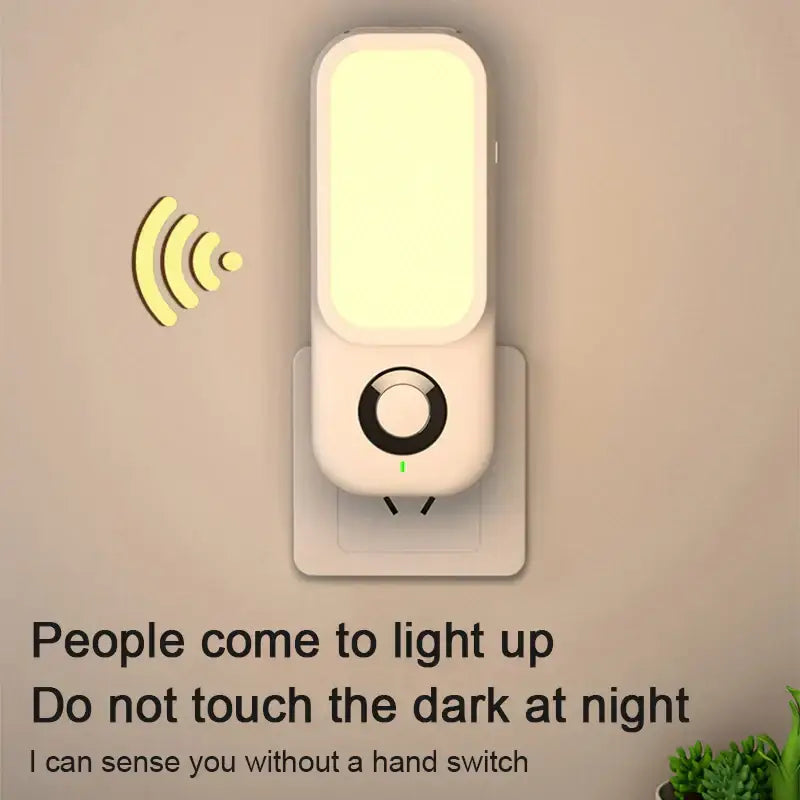 A sleek off-white DecorBites LED induction night light with rectangular LED panel and circular control button for wireless charging