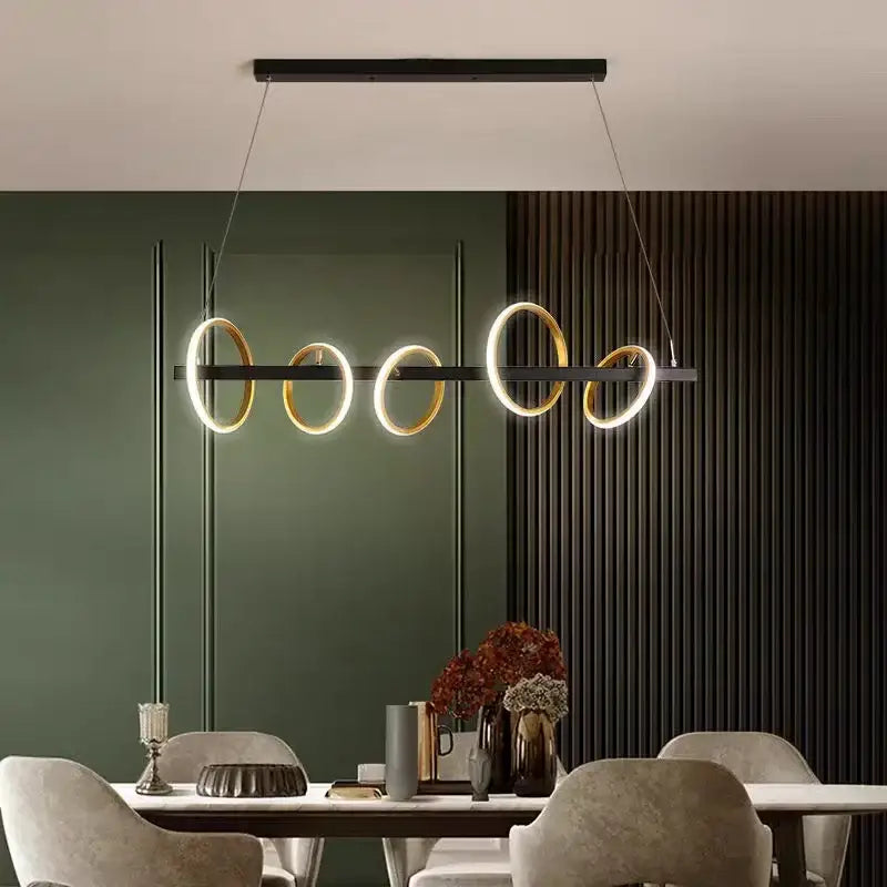 Modern minimalist decorbites led industrial chandelier with five glowing gold and black circular rings for dining room