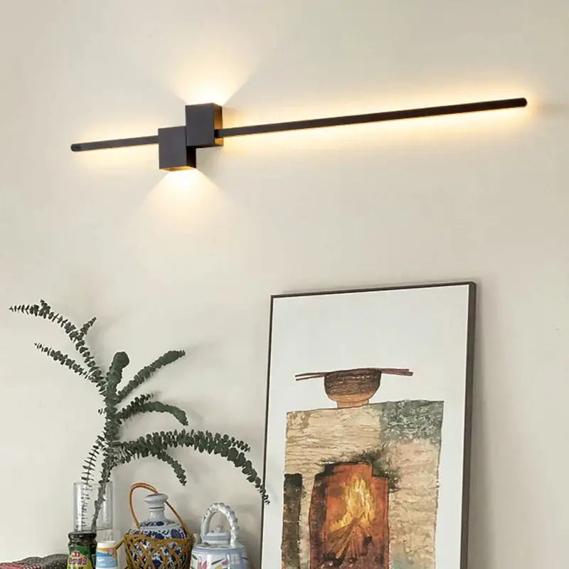 Modern black metal wall lamp with sleek minimalist design and warm ambient lighting by DecorBites led interior wall