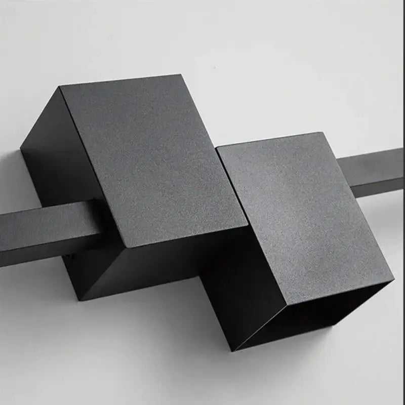 Black matte-finished geometric decorbites led interior wall lamp with angular cube shapes for modern minimalist lighting