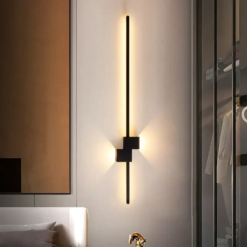 Modern black decorbites led interior wall lamp with minimalist vertical rod and cube base emitting warm ambient light